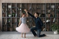 Daughter in fluffy skirt swirling enjoy dance with daddy Royalty Free Stock Photo