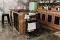 Cozy loft kitchen with dinning table, chairs and metal storage racks on wheels - trolley Royalty Free Stock Photo