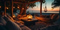 cozy Luxury resort, evening beach, candles blurred light on table ,sofa, hammock on front sunset sea