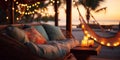 cozy Luxury resort, evening beach, candles blurred light on table ,sofa, hammock on front sunset sea