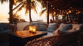 cozy Luxury resort, evening beach, candles blurred light on table ,sofa, hammock on front sunset sea