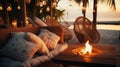 cozy Luxury resort, evening beach, candles blurred light on table ,sofa, hammock on front sunset sea