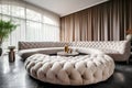 Cozy luxury tufted curved round sofa and velvet pouf on black parquet flooring against curtains near arched window. Hollywood