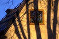 Cozy mansarde, tree shadows on the facade