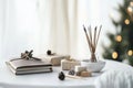Cozy meditation space featuring journals, incense sticks, and small gift boxes on a white table with soft natural light creating a Royalty Free Stock Photo