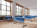 Cozy minimalist classroom interior with blue desk in row and panoramic window Royalty Free Stock Photo