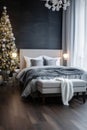 Cozy modern bedroom in white and gray colors with bed near window and Christmas tree in angle. Royalty Free Stock Photo