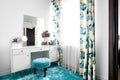 modern feminine white dressing room with minimalist vanity table and mirror