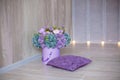 Cozy modern home with decor inspired by designers and florist soul with royal violet colors. Purple pillow with composition with