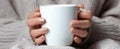 The cozy moment of hands holding a warm coffee mug in a sweater..AI generated image Royalty Free Stock Photo