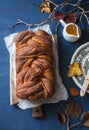 Cozy mood autumn still life with pumpkin cinnamon brioche on a blue table