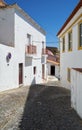 Cozy narrow paved streets with white houses inside the old city