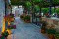 Cozy narrow street and garden decorated with colorful flowers Royalty Free Stock Photo