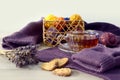 Cozy needlework time: a cup of tea on purple knitwear, skeins of multi-colored threads, a bouquet of lavender, heart-shaped