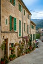 Cozy old street filled with flower pots in the charming village of Valldemossa, Mallorca Royalty Free Stock Photo