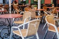 Cozy outdoor cafe in the open air. Wicker chairs and tables in an empty open-air restaurant Royalty Free Stock Photo