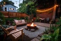 cozy outdoor patio with fire pit, seating and book rack for warm evenings