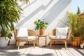 Cozy outdoor roof terrace or patio with armchairs and potted plants