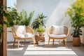 Cozy outdoor roof terrace or patio with armchairs and potted plants