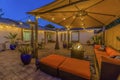 Cozy outdoor seating area under a pavilion on the patio paved with stone bricks