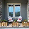 A cozy peaceful front porch of a house with adirondack chairs and flower planters Royalty Free Stock Photo