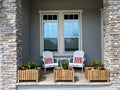 A cozy peaceful front porch of a house with adirondack chairs and flower planters Royalty Free Stock Photo