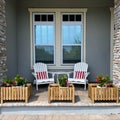 A cozy peaceful front porch of a house with adirondack chairs and flower planters Royalty Free Stock Photo