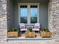 A cozy peaceful front porch of a house with adirondack chairs and flower planters Royalty Free Stock Photo