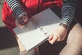 Cozy photo of woman writing in notebook sitting on the floor Royalty Free Stock Photo