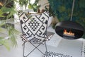 A cozy picnic chair by a hanging fireplace with a ceiling mount.