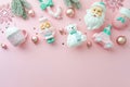Cozy pink Christmas flat lay border with Santa, nutcracker, and candy cane Royalty Free Stock Photo