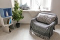 Cozy place for rest with armchair near window in light room Royalty Free Stock Photo