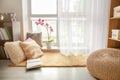 Cozy place for rest with soft pillows and book near window Royalty Free Stock Photo