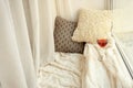 Cozy place for rest with soft pillows and wine near window Royalty Free Stock Photo