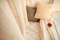 Cozy place for rest with soft pillows and wine near window Royalty Free Stock Photo