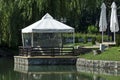 A cozy place for a summer relaxation with a friend under the sunshade in Ariana Lake, park  Borisova gradina Royalty Free Stock Photo