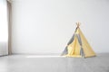 Cozy play tent for kids as element of nursery interior in empty room Royalty Free Stock Photo