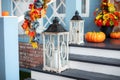 Cozy porch of the house with wooden lanterns in fall time.