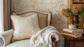 A cozy reading nook in the living room accented with a textured wallpaper featuring a delicate brocade pattern in a warm