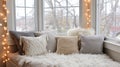Cozy reading nook in a winter setting with warm lights and soft pillows by the window Royalty Free Stock Photo