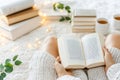 Cozy reading space with open book and warm tea on a soft blanket