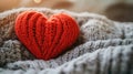 Cozy Red Knitted Heart on Soft Gray Fabric Royalty Free Stock Photo