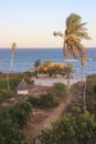 Cozy resort house with coconut trees on the shores of the Indian Ocean in Kenya. Royalty Free Stock Photo