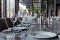 Modern veranda restaurant interior, banquet setting, glasses, plates