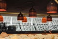 Cozy restaurant interior with warm lighting and woven pendant lamps Royalty Free Stock Photo