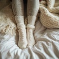 Cozy retreat legs in warm leggings and wool socks under blanket