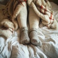 Cozy retreat legs in warm leggings and wool socks under blanket
