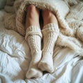 Cozy retreat legs in warm leggings and wool socks under blanket