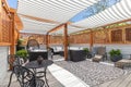 A cozy rooftop patio with a covered pergola.