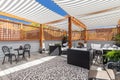 A cozy rooftop patio with a covered pergola.